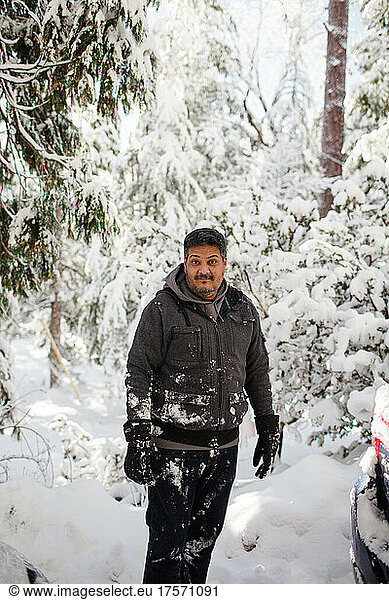 Mexican Man in Mid 40's Standing in Snow in Idyllwild