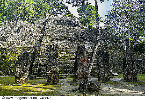 Mexico  Campeche  Menhirs standing in front of ancient Maya temple in Calakmul
