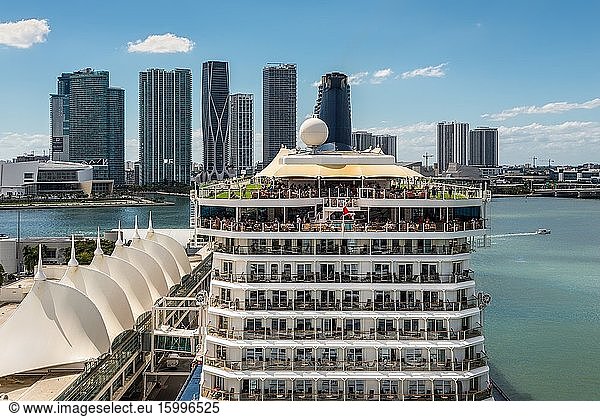 Miami  FL  United States - April 20  2019: The Celebrity Equinox Cruise ship docked at Miami Cruise ship terminal with skyscrapers in the background at Miami  Florida  United States of America.