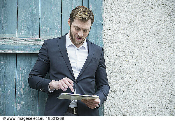 Mid adult businessman using digital tablet outside  Bavaria  Germany