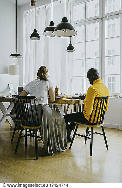 Mid adult man and woman having breakfast together at home