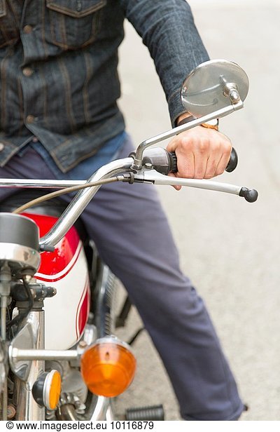 Mid adult man on motorbike  mid section