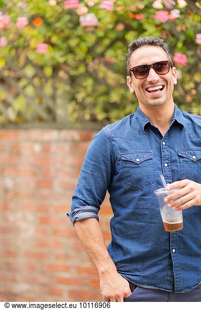 Mid adult man  outdoors  holding drink