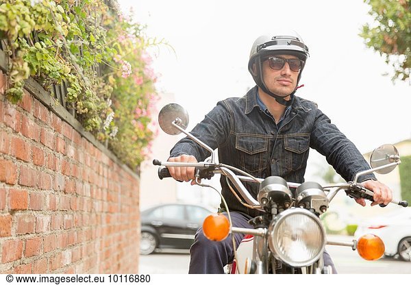 Mid adult man riding motorbike