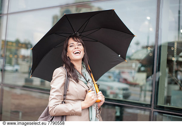Mid adult woman holding umbrella