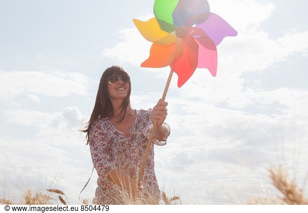 Mid adult woman holding windmill