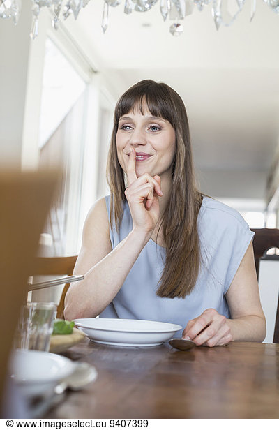 Mid adult woman sitting at table