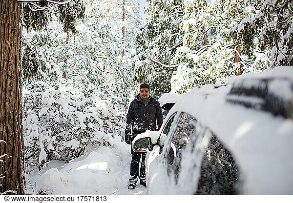 Mid 40's Mexican Man Standing in Snow in Idyllwild