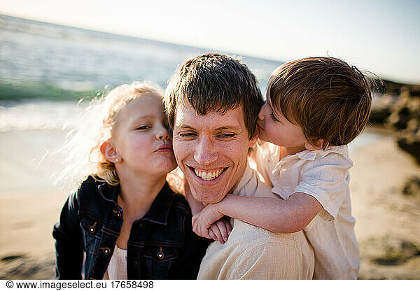 Mid Thirties Dad Getting Kisses from Son & Daughter in San Diego