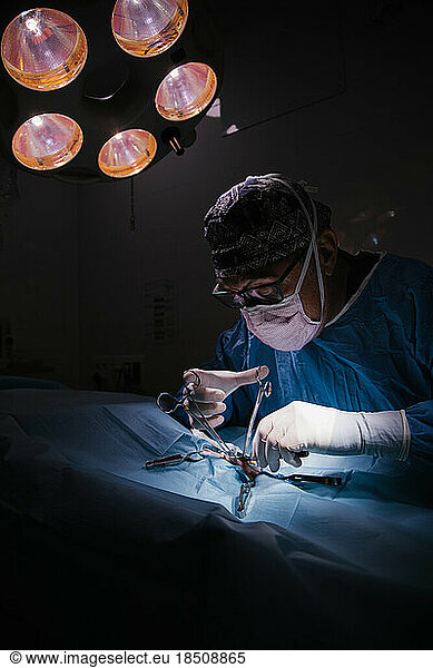 middle-aged male surgeon operating in an operating room