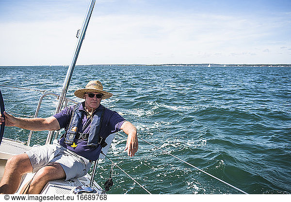 Middle Aged Man Sailing on a sunny day