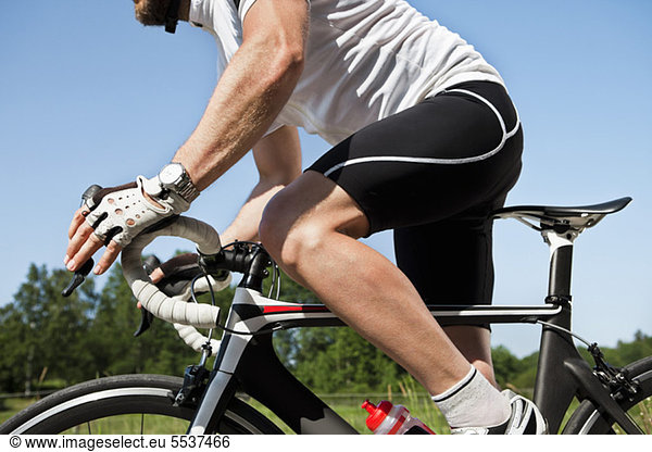 Midsection of male cyclist riding cycle