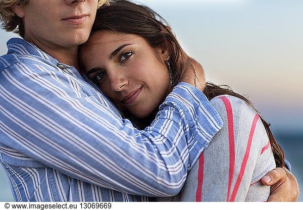 Midsection of man embracing girlfriend