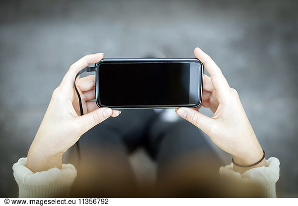 Midsection of woman using phone
