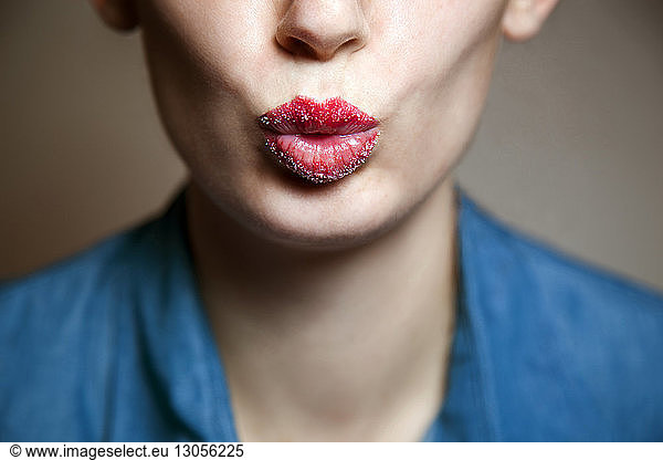 Midsection of woman with sugar covered lips