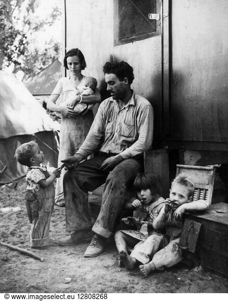 MIGRANT CAMP  1935. An ex-tenant farmer from Texas with his family in a camp for migrant workers during peach harvest in Marysville  California. Photograph by Dorothea Lange  September 1935.