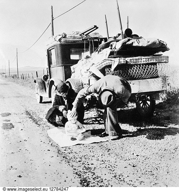 MIGRANT FAMILY  1937. A migrant family from Missouri halts on a California highway  February 1937. Photographed by Dorothea Lange.
