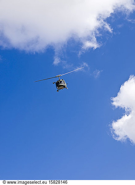 Military helicopter against a deep blue sky