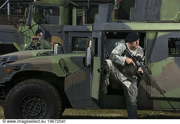 Military police officers secure tactical vehicles on base.