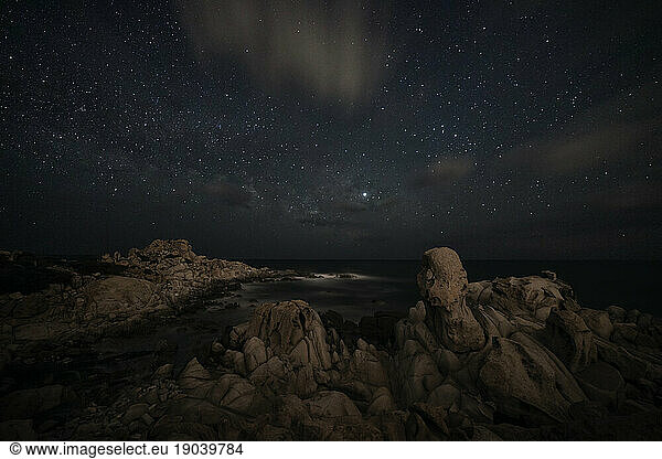 Milky way over a cliff on a cloudy night
