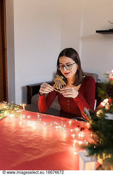 Millennial-Frau mit Weihnachtsschmuck in festlicher Atmosphäre