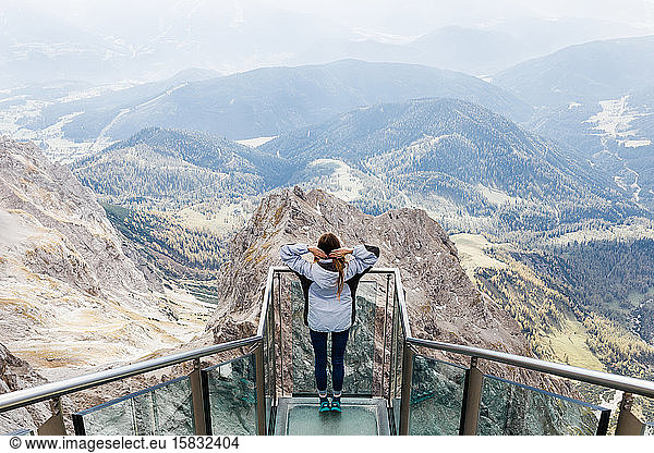 millennial girl enjoys the views of Alps from the observation deck