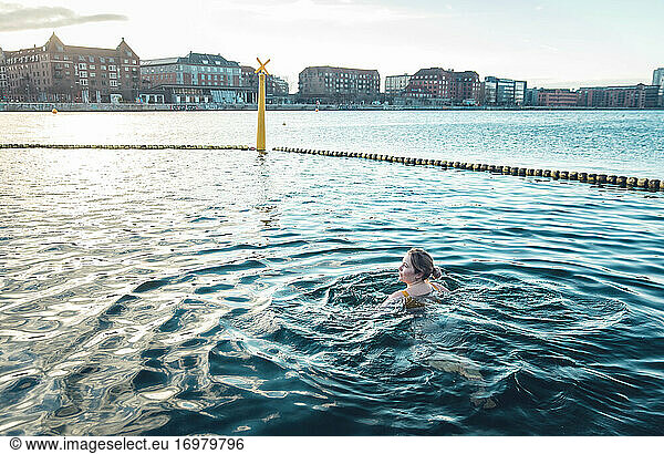Millennial Peacefully Swimming in Cold Water In Copenhagen Denmark