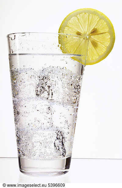 Mineral water with ice-cubes and a slice of lemon