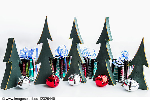 Miniatur-Holzbäume  Glocken und verpackte Geschenke als Weihnachtsschmuck