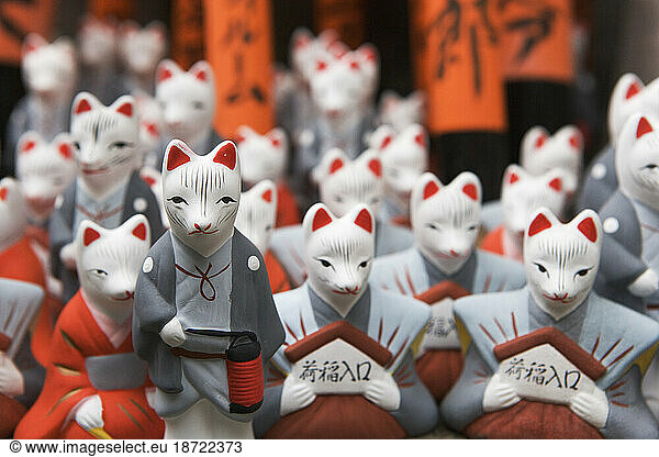 Miniature fox statues at the Fushimi Inari Shrine  Kyoto  Japan