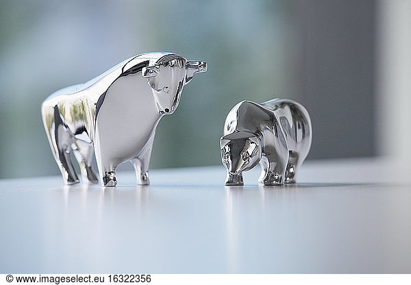 Miniature sculptures of bull and bear on a desk