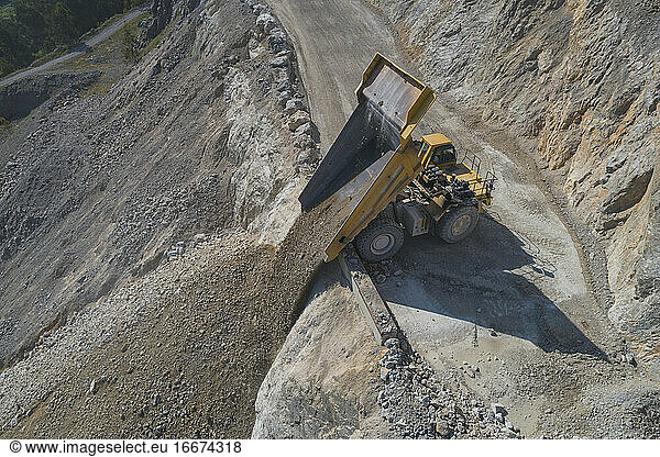 Mining Dumper unloading from aerial view