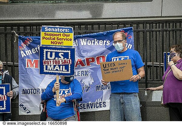 Minneapolis  Minnesota  Postal workers rally to demand that Congress act to save the Postal Service  Protesters with masks holding signs.