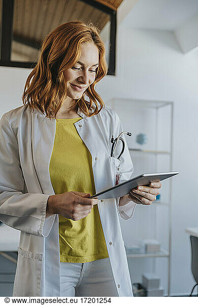 Mitarbeiterin im Gesundheitswesen bei der Arbeit an einem digitalen Tablet in einer Klinik