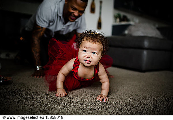 Mixed Race Baby Crawling as Dad Follows Behind