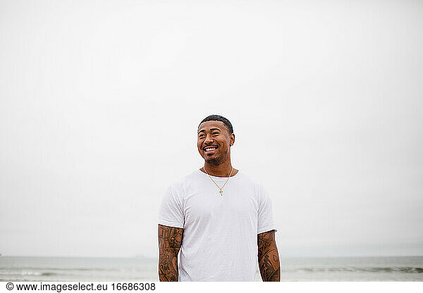 Mixed Race Man Smiling at Beach
