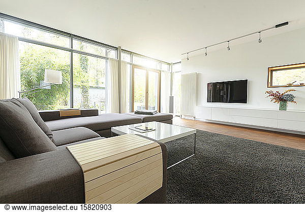 Modern living room in design house with large windows