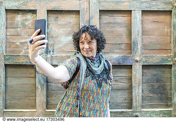 modern middle-aged woman taking a photo from her smartphone