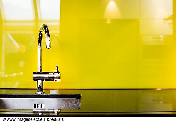 Modern stainless steel faucet and sink near poisen green wall  retro design beauty luxury.