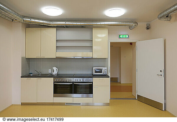 Modern youth hostel building. Kitchen with two ovens  kettle and toaster.
