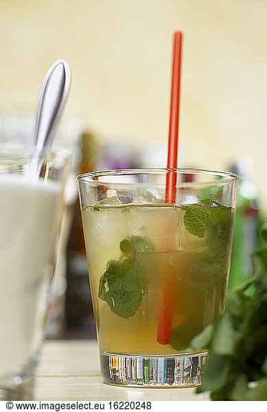 Mojito cocktail with mint and drinking straw  close-up
