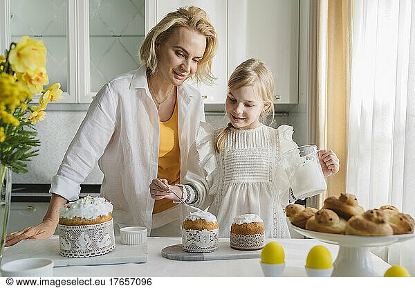 Mom and daughter cook together in the kitchen.