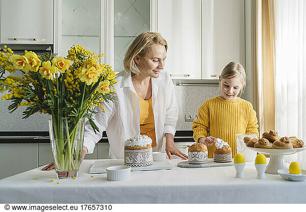 Mom and daughter cook together in the kitchen.
