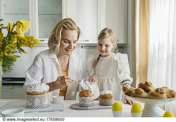 Mom and daughter cook together in the kitchen.