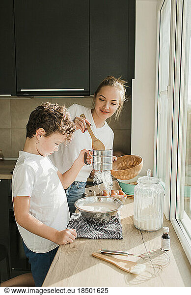 mom and son cook a pie together