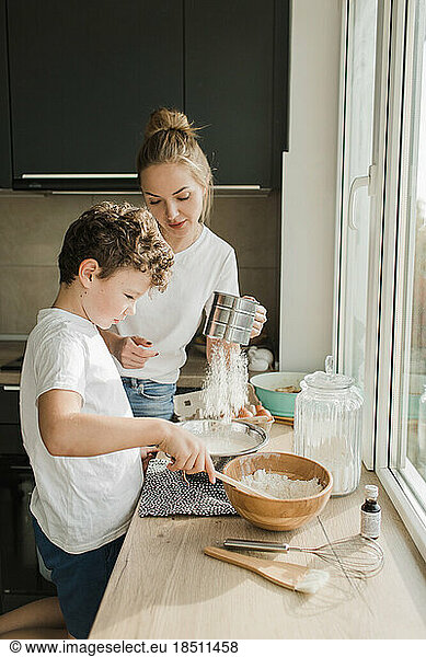 mom and son cook a pie together