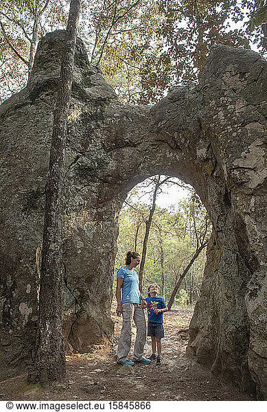 Mom and son under a natural arch in a rock at Huasca de Ocampo  Mexico