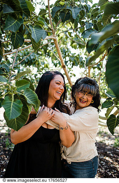 Mom & Daughter Laughing  Surrounded by Trees in San Diego