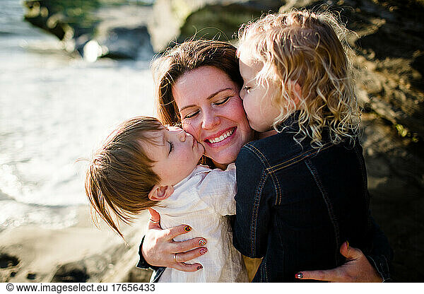Mom Getting Kisses from Kids on Beach in San Diego