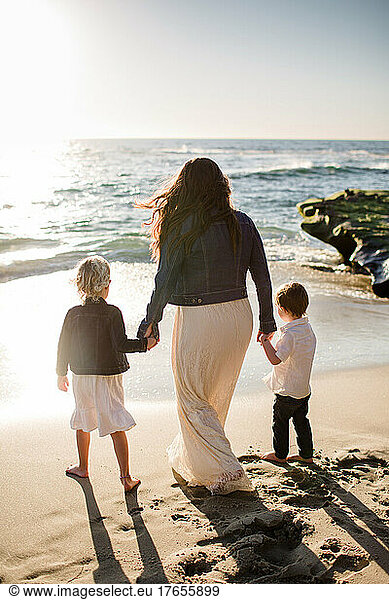 Mom Holding Hands with Young Children on Beach in San Diego